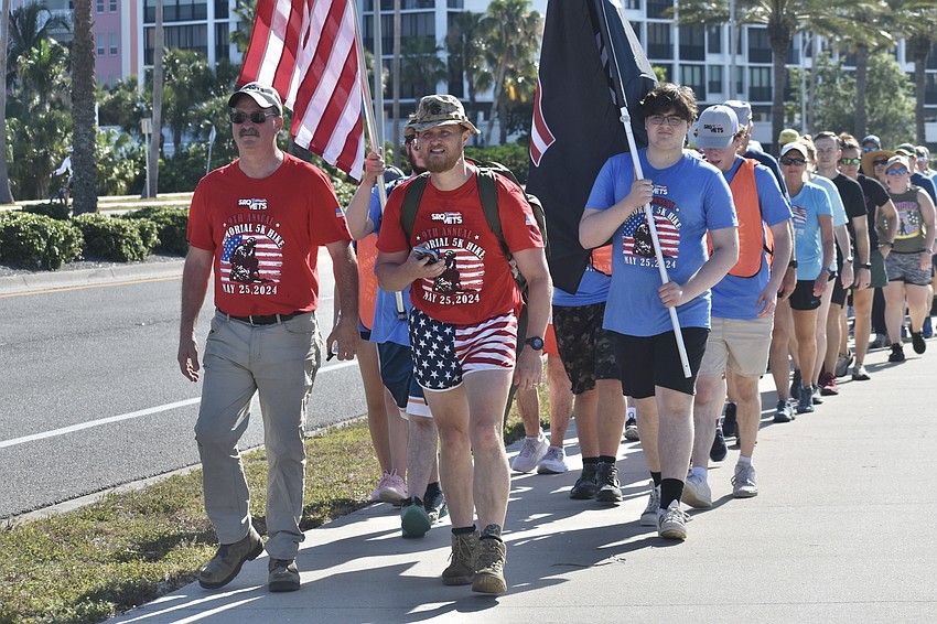 Rob Kehs, board president of SRQ VETS, and board member Ben Voorhees, lead the hike as they lead the walk along Bayfront Drive.