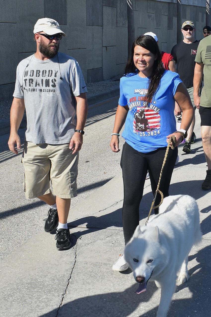 Jake Frankeart, Jessica Hughes and Ghost walk beside the Ringling Causeway.