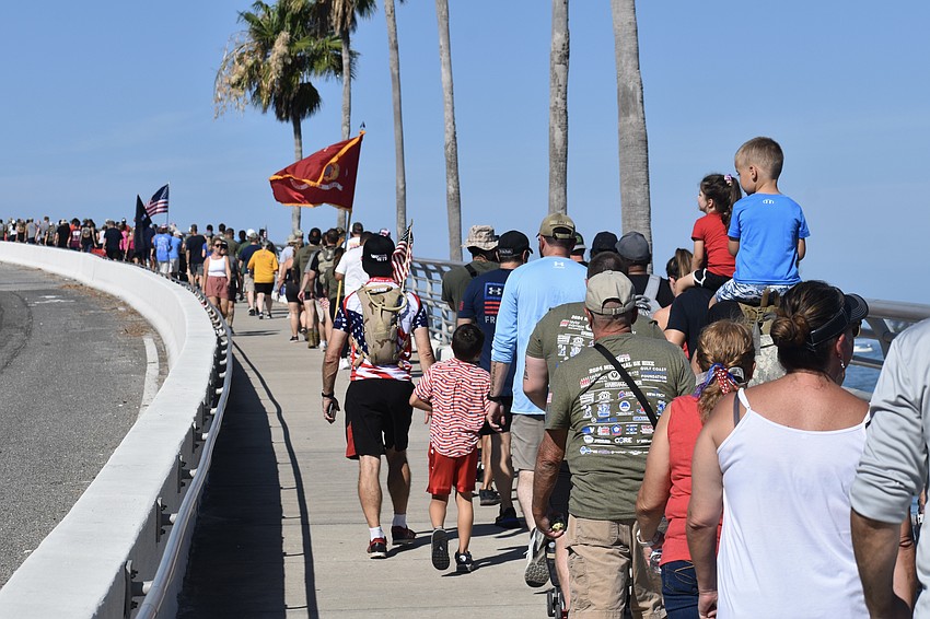 Hikers make their way up the bridge.