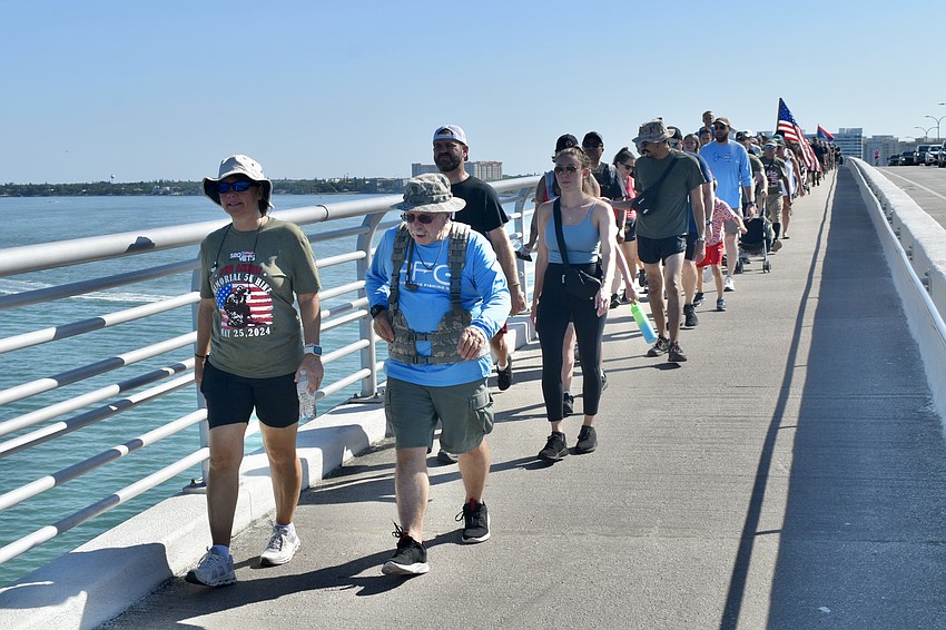 Hikers make their way across the bridge, with Dave Taylor and Danielle Robbins in front.