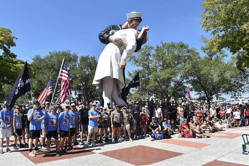 Hikers gather at the Unconditional Surrender statue after the walk.