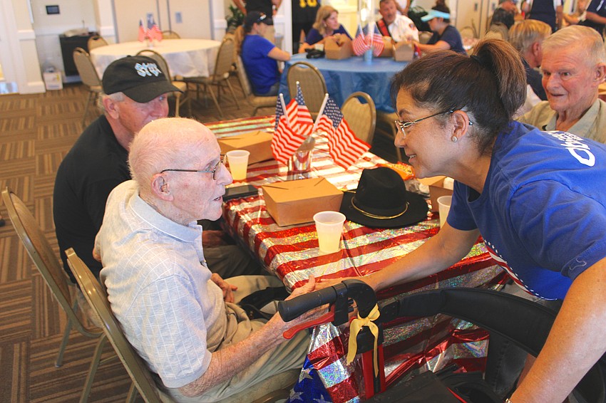 World War II veteran John Skeen chats with the East County Observer's Lori Ruth during the veterans dinner at Lakewood Ranch Town Hall before the Tribute to Heroes Parade. Ruth always helps organize the dinner.