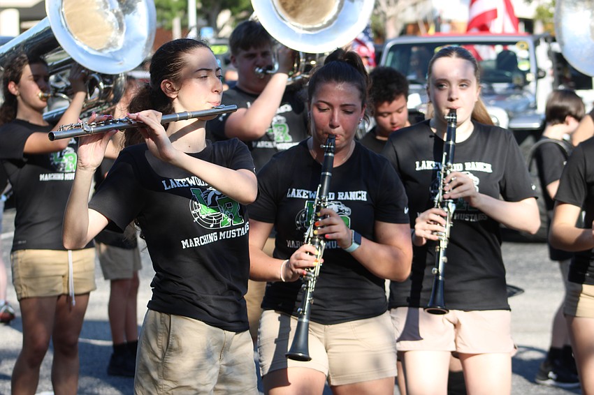 Members of the Lakewood Ranch High Marching Mustangs practice before the Tribute to Heroes Parade.
