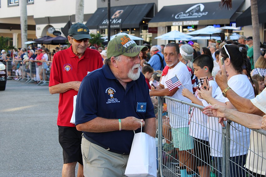 William Jacques of the Knights of Columbus hands out goodies to the crowd during the Tribute to Heroes Parade.