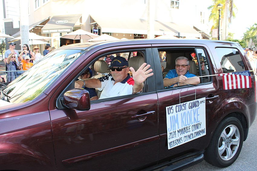 U.S. Coast Guard veteran Jim Klocke enjoys a special ride during the Tribute to Heroes Parade.