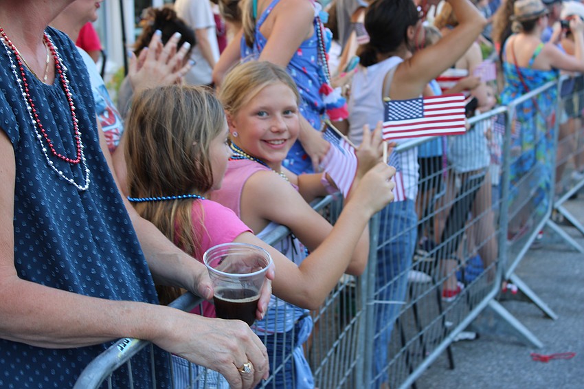Lakewood Ranch 9-year-old Olivia Zeller enjoys the Tribute to Heroes Parade with Matelyn Favero (to her left), also a 9-year-old Lakewood Ranch resident.
