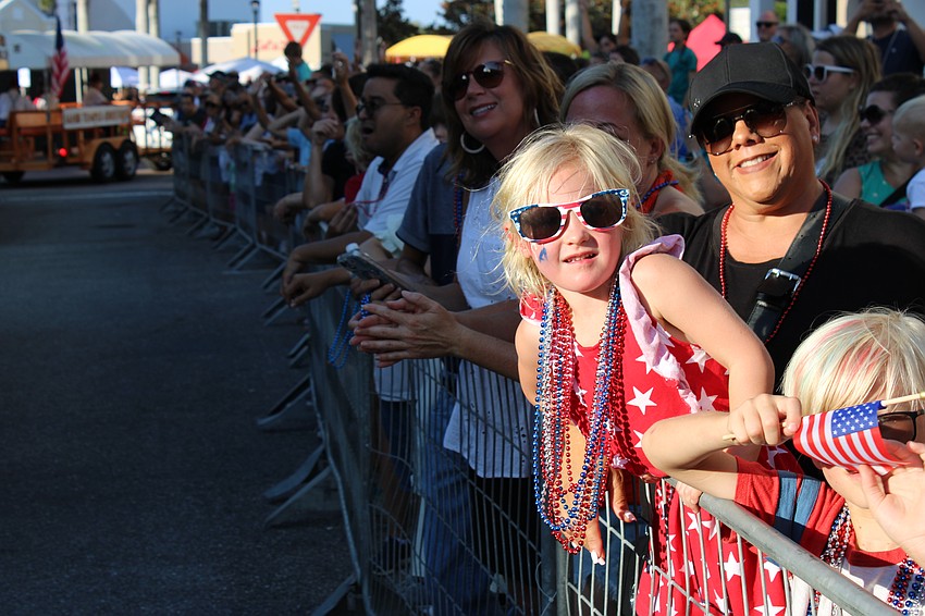 Sarasota 4-year-old Alona Hymel is in fashion, sporting the beads she collected at the Tribute to Heroes Parade in Lakewood Ranch.