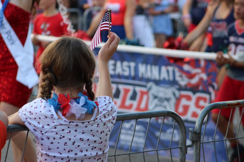 Many in the thousands who attended the Tribute to Heroes parade brought American flags with them.