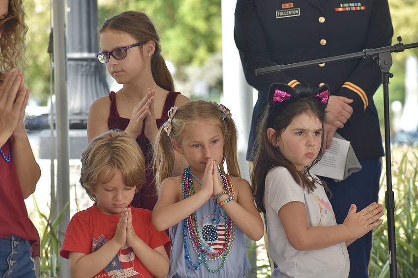 Liam Shepherd, 4, Sophia Christeas, 11, Scarlett Shepherd, 7 and Hannah Harkness, 5, took to the podium to join Jan Solomon for the invocation.