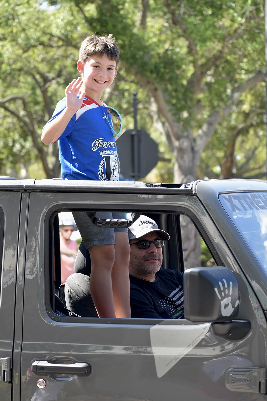 Little Sal Logrande, 9, and Sal Logrande, make their way down Main Street.