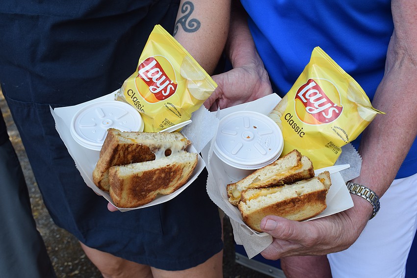 Two gourmet classic grilled cheeses with homemade tomato soup and chips from Big Blue Grilled Cheese Company food truck.