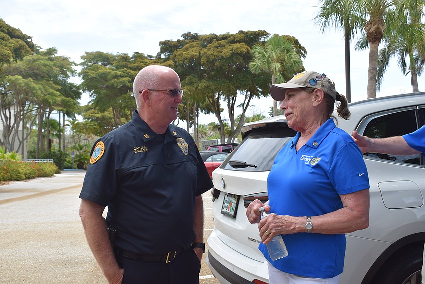 Nancy Rozance congratulating Captain Robert Bourque on being Manatee County Hundred Club’s 2023 Officer of the Year.