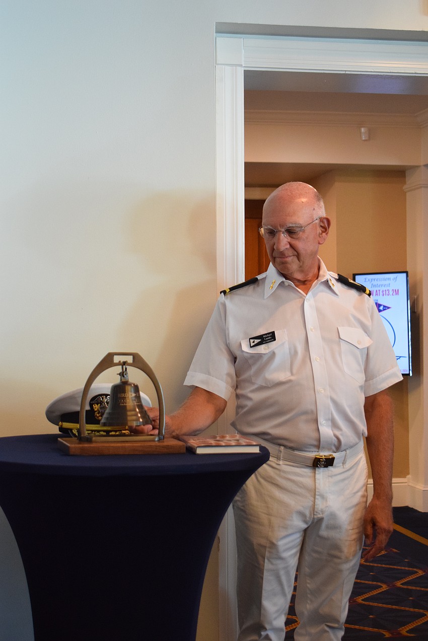 Vice Commodore Michael Landis ringing the bell for fallen soldiers.