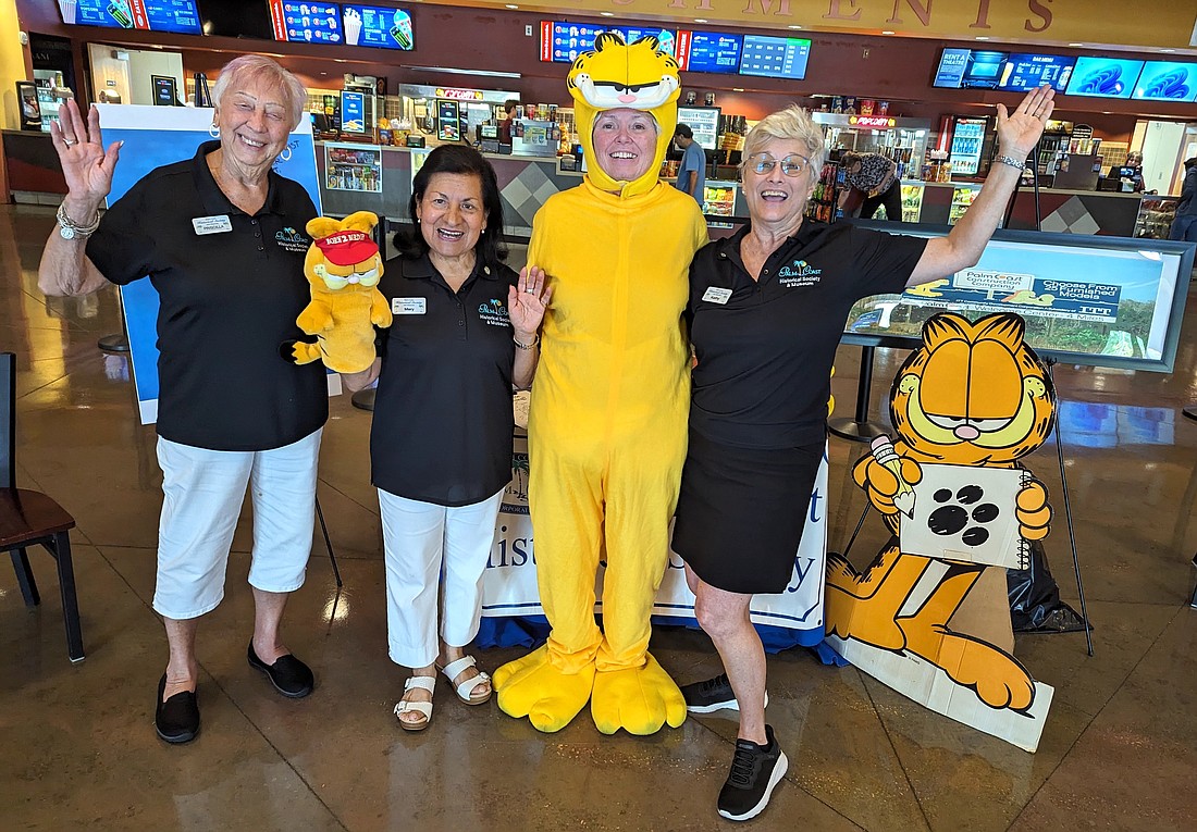 Palm Coast Historical Society's Priscilla Netts, Mery Gable, Margaret Leon (in Garfield costume) and Kathy Reichard-Ellavsky at Epic Theatres of Palm Coast. Photo by Brent Woronoff