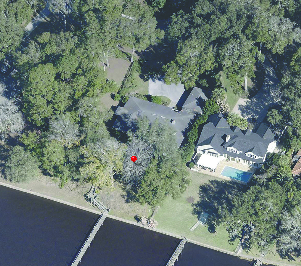 Riverfront single-story home in Miramar. Features four bedrooms, three full and one half-bathroom, porches, pool dock and covered boatlift.