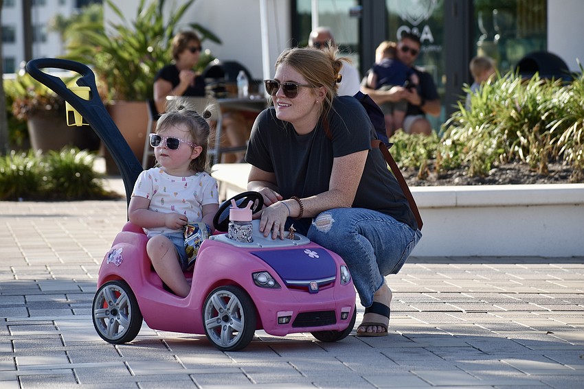 Bradenton residents Bree and Britnie Ellis listen to music while waiting on friends to join them at Ranch Nite Wednesday.