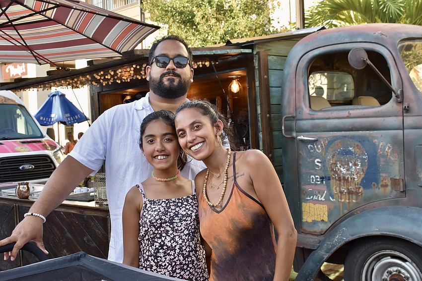 Sarasota residents Jordan, Isabella and Jaime Colon wait in line for a wood fired pizza.
