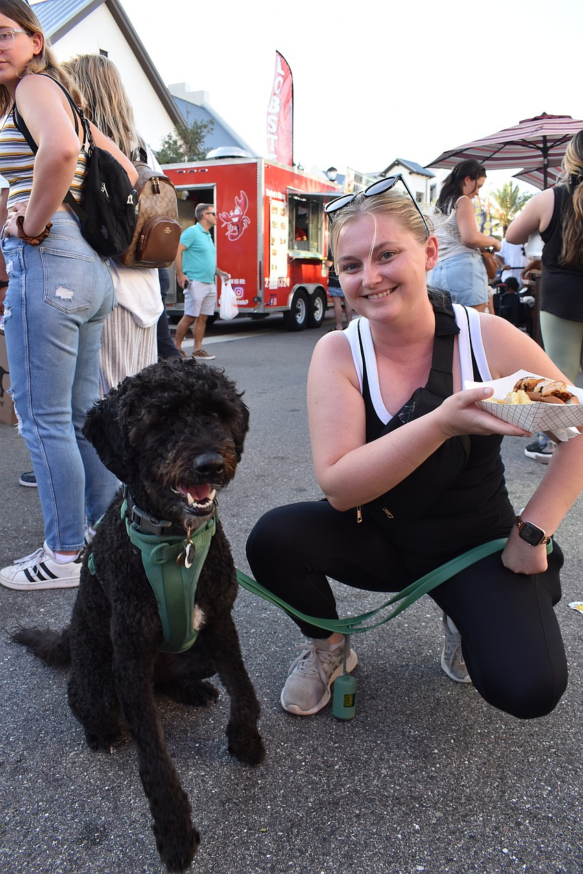 Parrish resident Mary Quaid leaves the Got Lobstah? truck with a blackened shrimp roll and her labradoodle Ted.