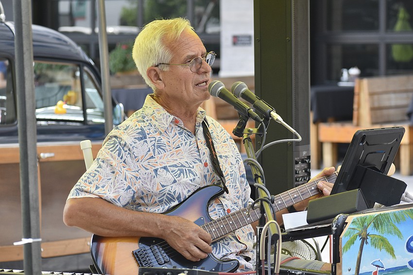 Siesta John performs at the market.