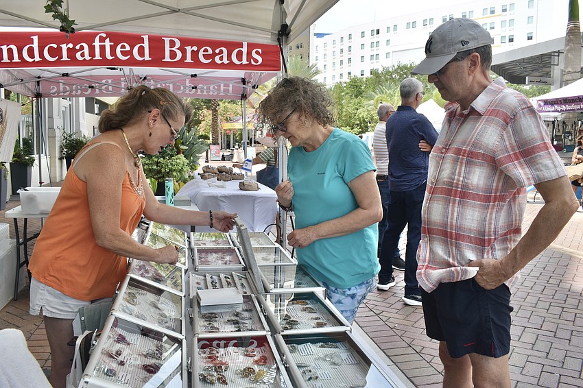 Terri Cisero of Terri's Treasures showcases her jewelry items to Jacqueline Steltz-Lenarsky and Robert Lischetti.