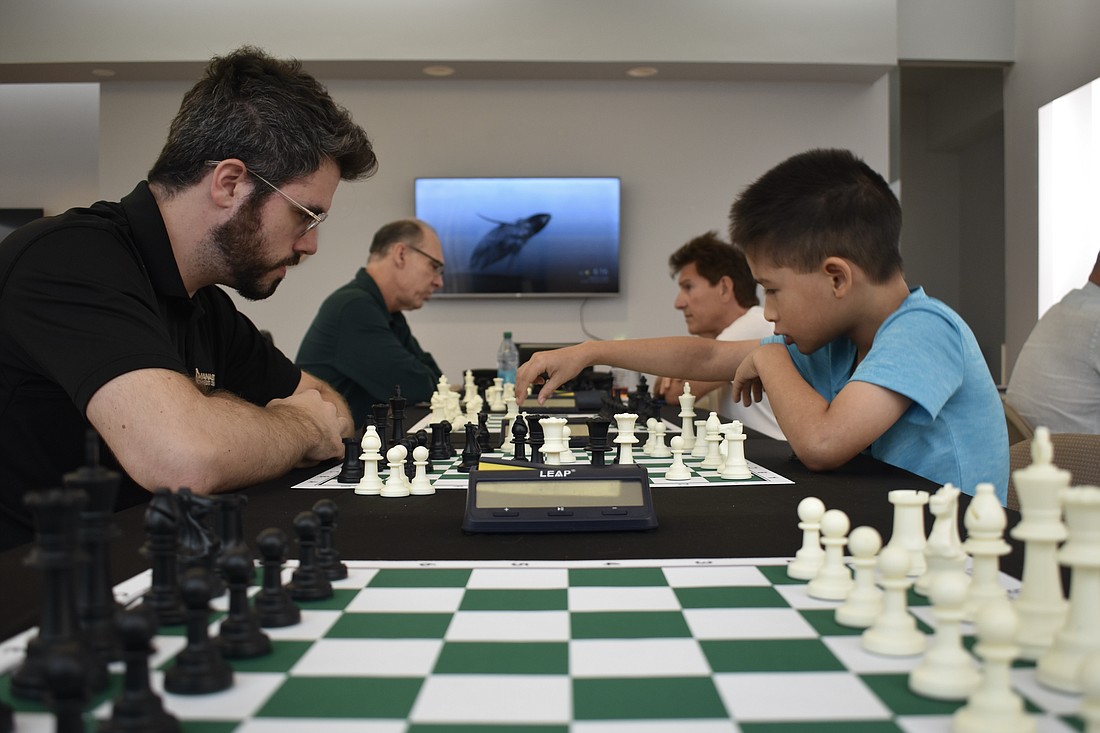 Nicholas Lewis, David Pratt, Mark Hamel and Evan Santiago, 9, play chess