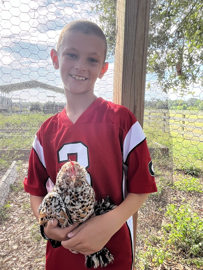 Graham Rueping, who is 9, doesn't want to leave the chicken coop.