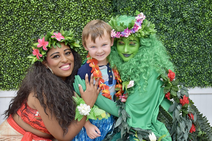 Moana (Priscilla Ward) and Te Fiti (Veronica Gonzalez) give 6-year-old Palmetto resident JB Layhew a big hug during the luau on June 7.