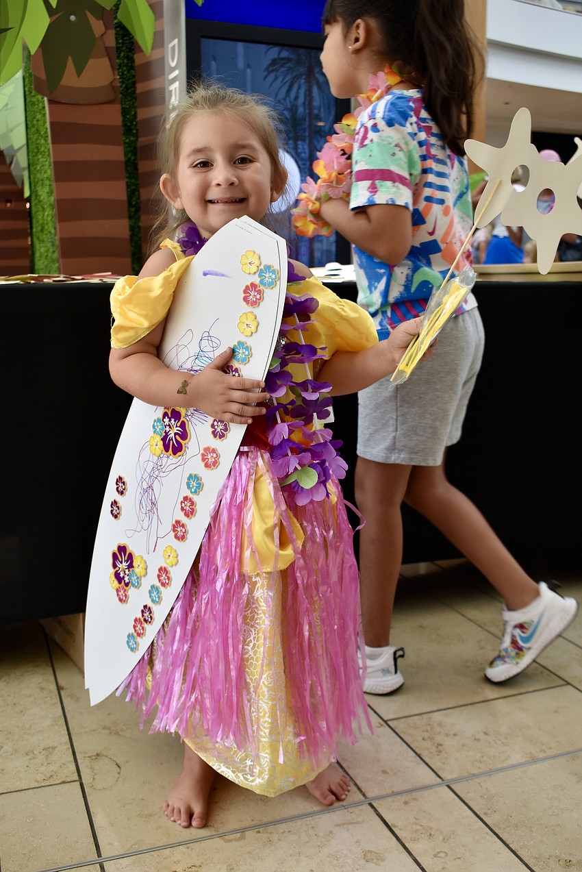 Bradenton resident and Disney fan Coral Mota, 3, doesn't have a Moana outfit, so she's wearing a grass skirt and lei over her Belle princess dress.