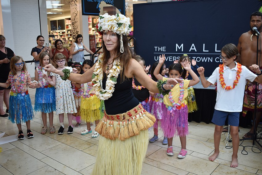 Nani Tiara leads the dancers with cues like coconut and watermelon. Fruit salad means to shake your hips really fast.