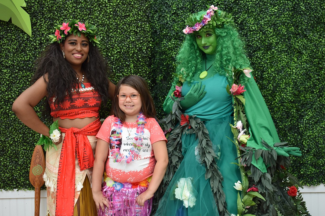 Moana (Priscilla Ward) and Te Fiti (Veronica Gonzalez) meet one of their biggest fans, 9-year-old Mackenzie Carney. Carney dressed for the occassion in a Moana T-shirt and matching bell bottom pants.