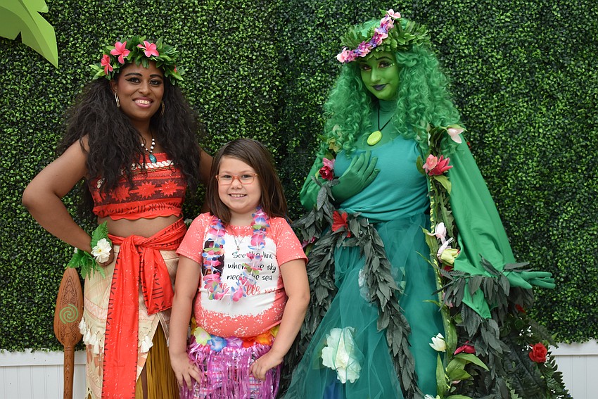 Moana (Priscilla Ward) and Te Fiti (Veronica Gonzalez) meet one of their biggest fans, 9-year-old Mackenzie Carney. Carney dressed for the occassion in a Moana T-shirt and matching bell bottom pants.