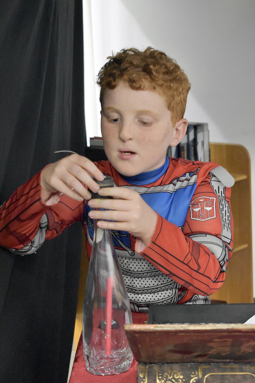 Camden Dillon, 8, works on the puzzles in the escape room.