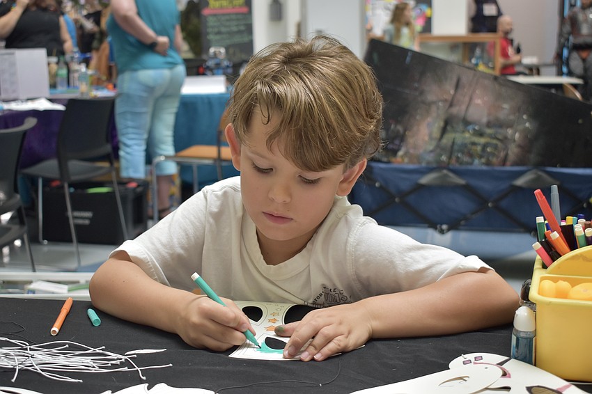 Sebastian Strauser, 6, designs a mask.