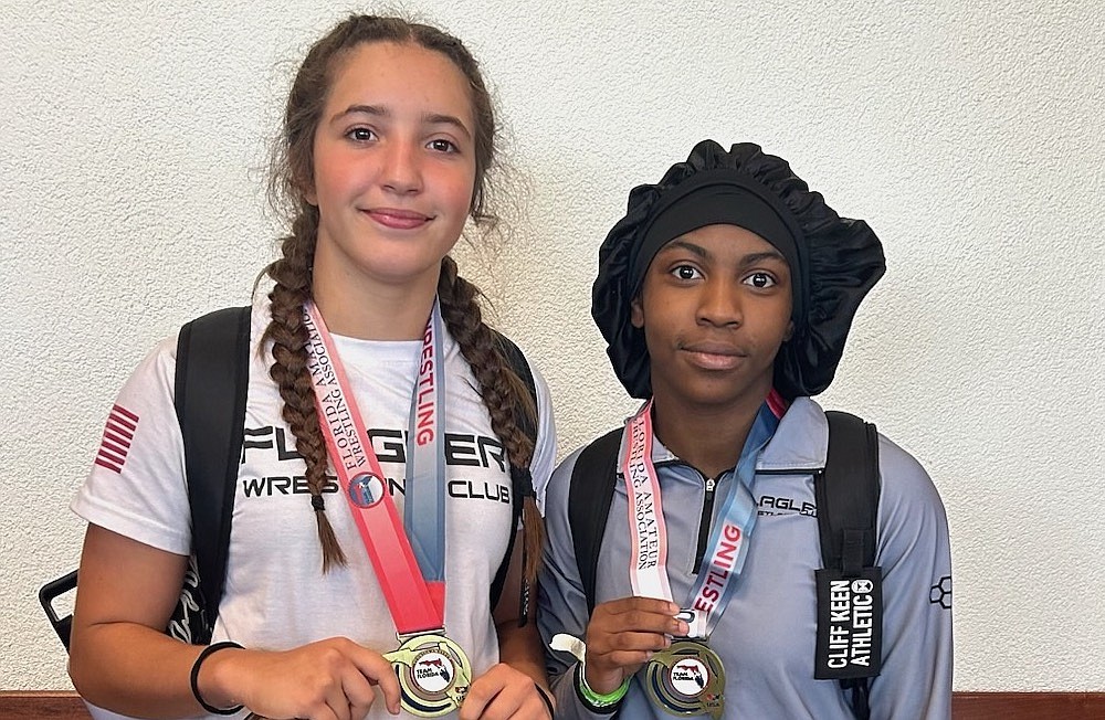 FPC's Alisha Vilar (left) and Joslyn Johnson show off their first-place medals at the FAWA Freestyle State Wrestling Championships. Courtesy photo