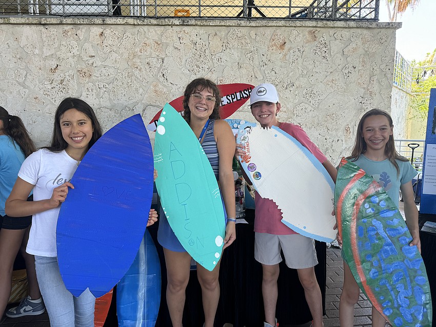 Love Gordon, Addison Riesen, Solomyn Hoinkas and Coco Claypoole show off their art made with recycled cardboard.
