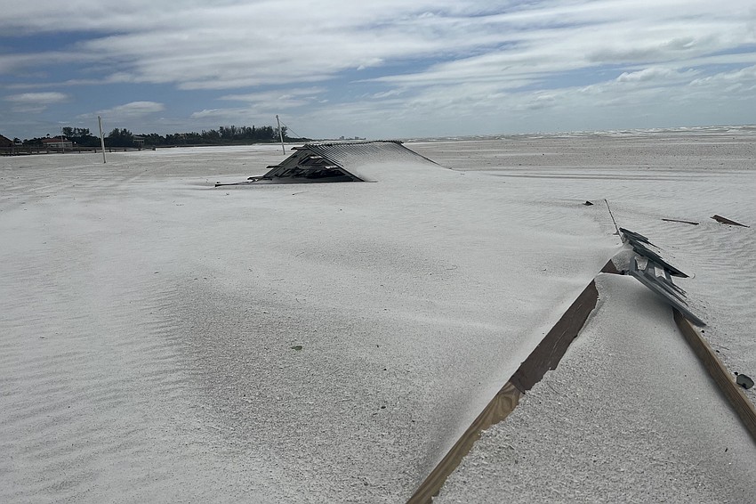 One of the Tiki huts from the Longboat Key Club lies in pieces on the beach in front of the club on Sept. 29, 2022, after Hurricane Ian.