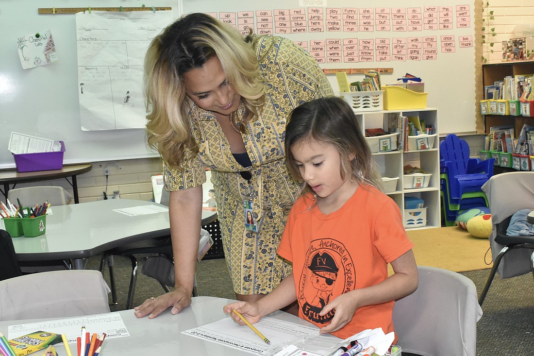 Gail Bowers, a kindergarten teacher at Fruitivlle Elementary, works with student Marina Prybylski.