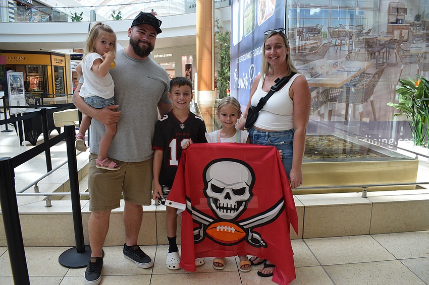 Lakewood Ranch 2-year-old Savanna Stoner waits in line to meet former Tampa Bay Buccaneers and Tampa Bay Lightning players with her dad, Brian Stoner, 8-year-old brother, Mason Stoner, 6-year-old sister, Emma Stoner, and mother, Casaundra Stoner.