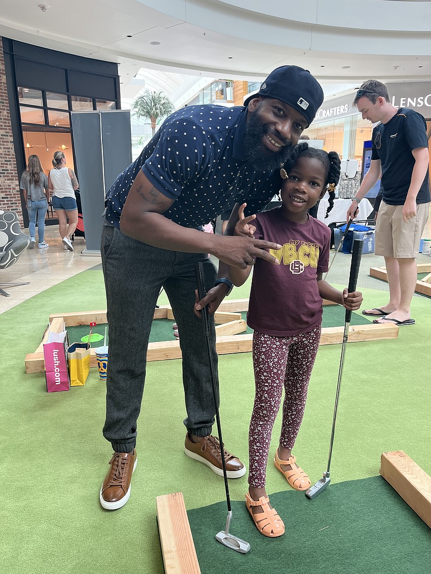 Sarasota's Frank Jenkins and 5-year-old Makinley Jenkins play mini golf together. 