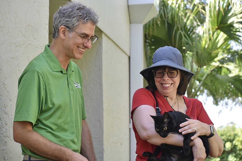 Rabbi Brenner Glickman meets with Susan Eriksen-Silver, who brought her two cats Bobbie Jones and Nellie (pictured).