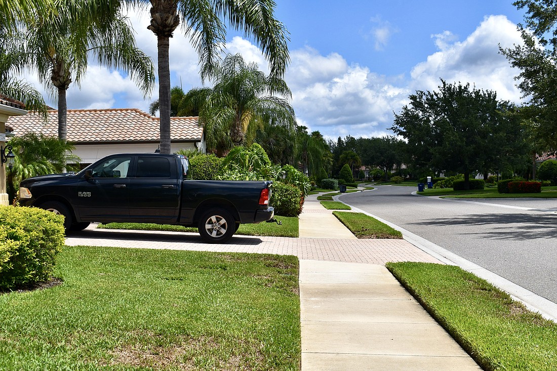 A pickup truck is parked in a driveway in Stone Ridge. Currently, the truck can't park in a driveway overnight in the Country Club, but as of July 1, the HOA will no longer be allowed to prohibit it.