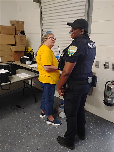 Nancy Barrett explains blood screening results to a police officer. Courtesy photo