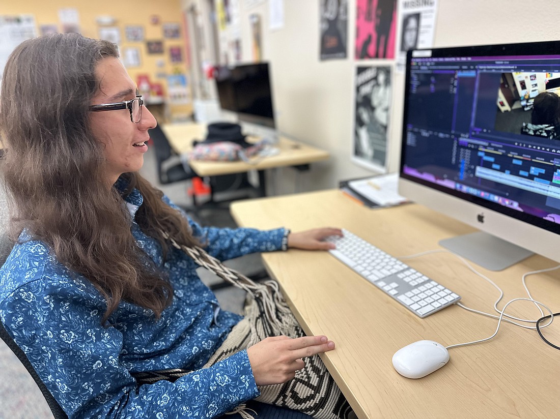 Andres Rodriguez, who graduated in May from Booker High School and Suncoast Technical College's digital video technology program, puts finishing touches on a music video he made as a graduation project.