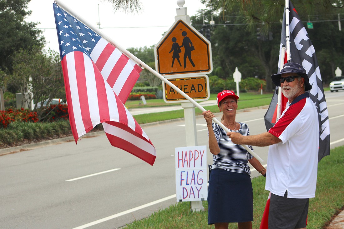 Lakewood Ranch's JoAnne and John Lawler bring attention to Flag Day on Lakewood Ranch Boulevard.