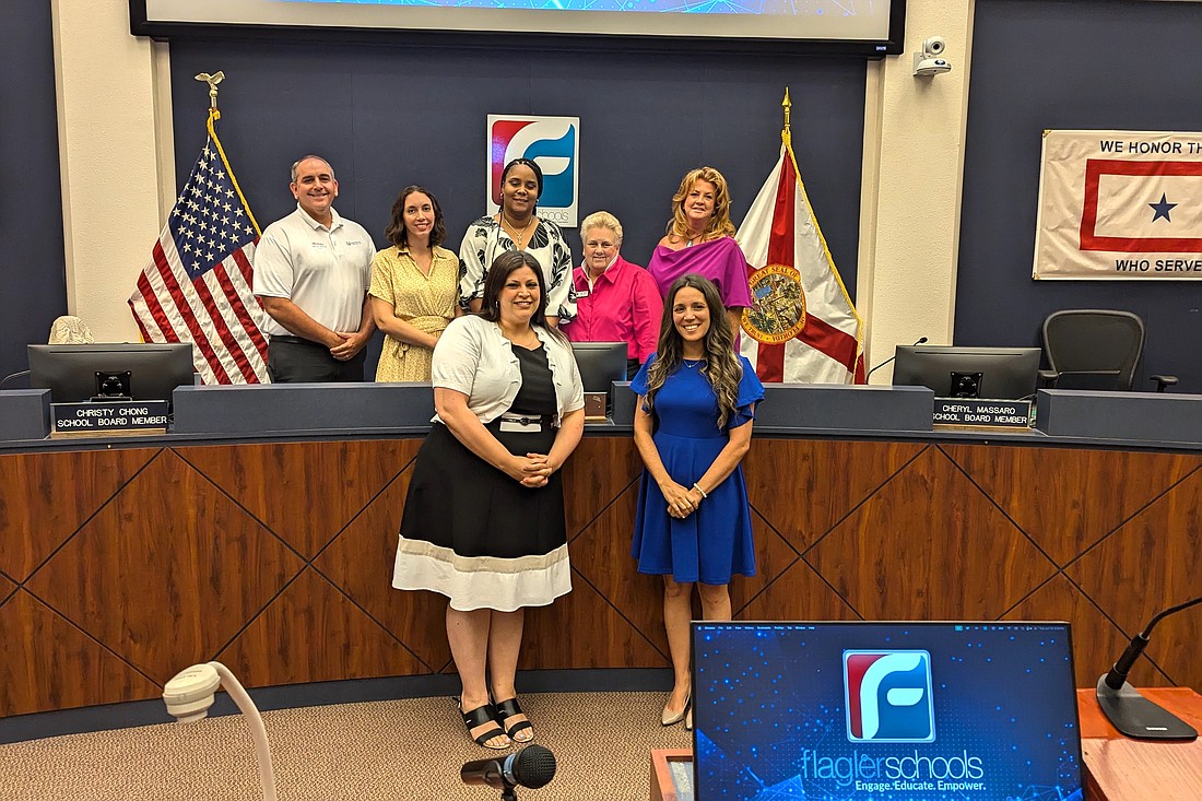 New Matanzas Assistant Principal Kara Minn (left) and Old Kings Elementary School Principal Jessica Fries pose with Flagler County School Board members and Superintendent LaShakia Moore (center, back row). Photo by Brent Woronoff