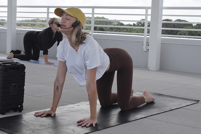 Courtenay Smith, the instructor at Rooftop Yoga, has everyone go into tabletop pose.