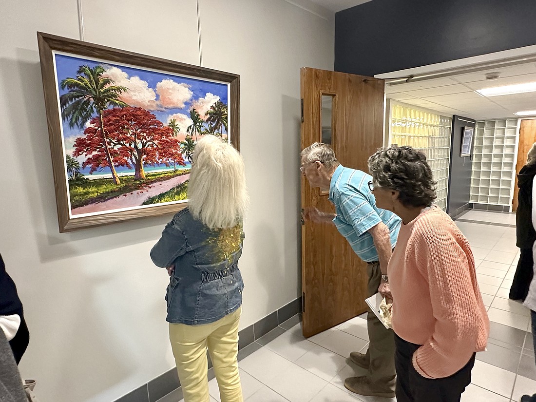 Visitors viewing the Florida Highwaymen exhibit in the atrium and lobby at Sarasota City Hall.