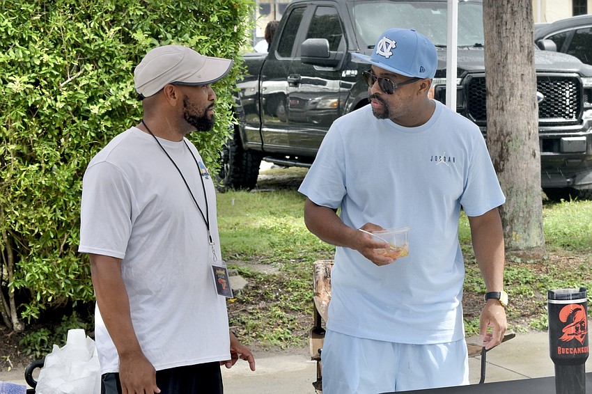 Commie Wheeler and Rob Jenkins of Tommy's Italian Ice chat with one another.