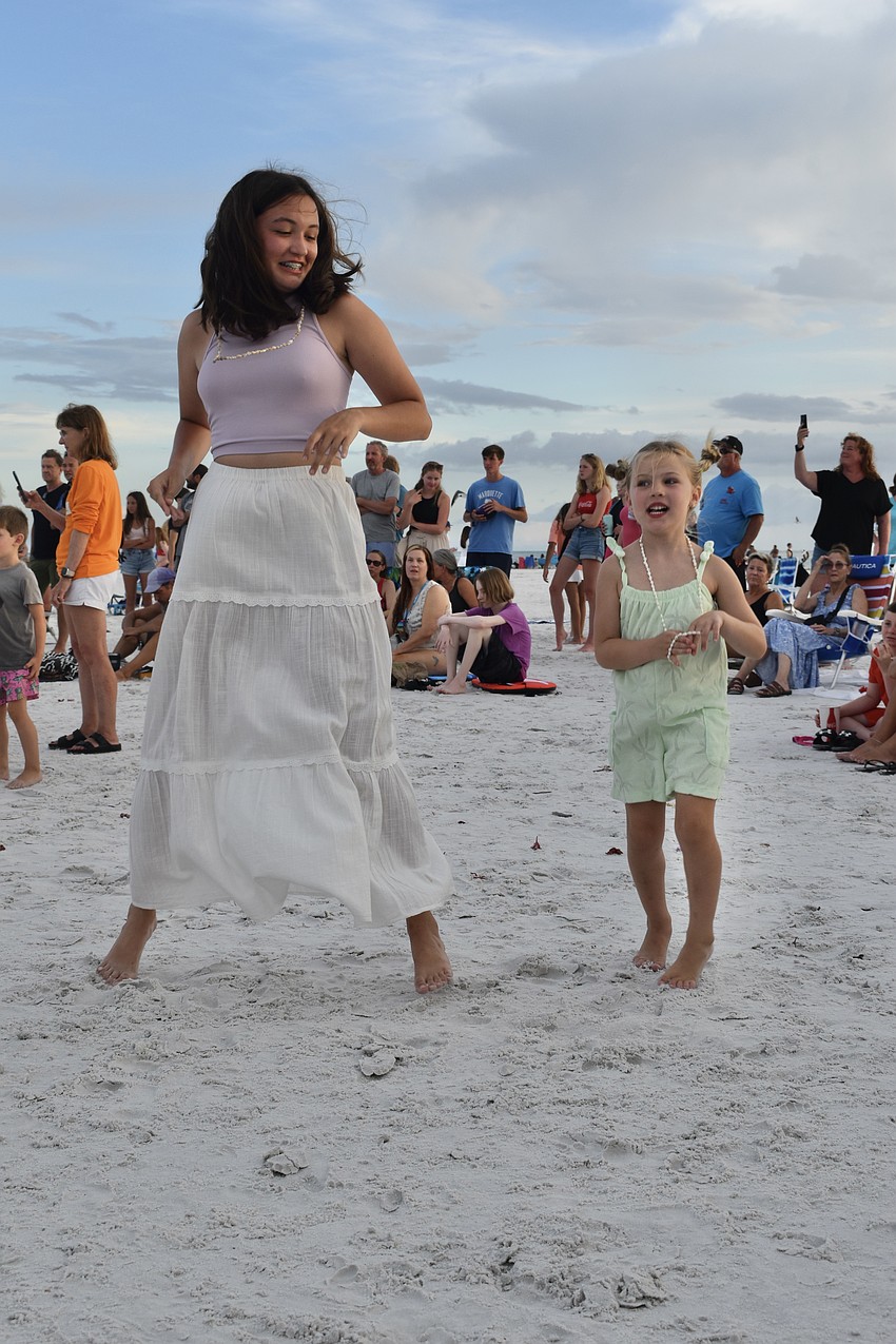 Izzy Gehbauer, 15 and Liv Evans, 5 of Cincinnati dance together.