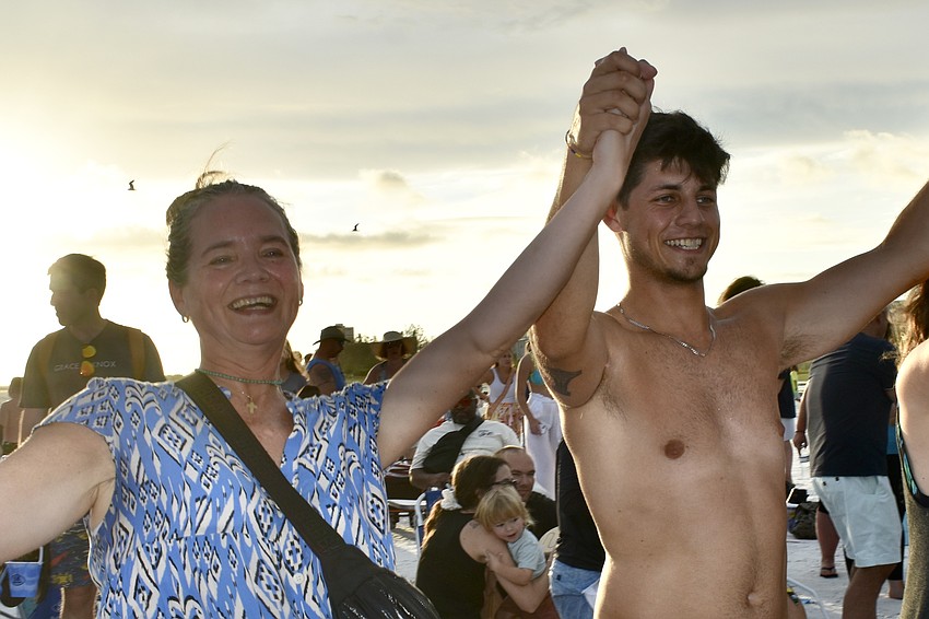 Maureen Murtagh and her son Pablo Ramirez, of Chile, take part in a line of dancers.